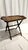 A stunning 1920s-1930s oak tray table featuring a gracefully foldable base for convenience and versatility. The rich oak...