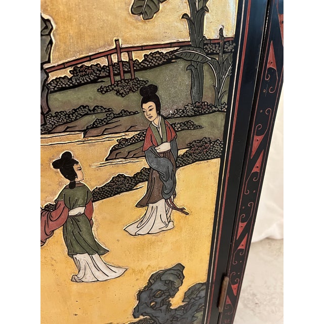 This is a beautiful Mid-Century (1950s) Chinese Black and Gold Lacquer Cabinet with Mother of Pearl Inlays. The beautiful...