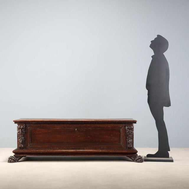 18th century walnut chest from Italy, featuring a dentilated underframe that adds elegance and detail. The front is...