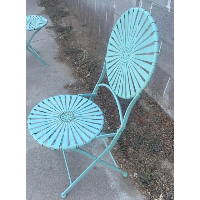 An exceptional, highly collectible mid-century modern three-piece metal outdoor bistro suite, confidently attributed to...