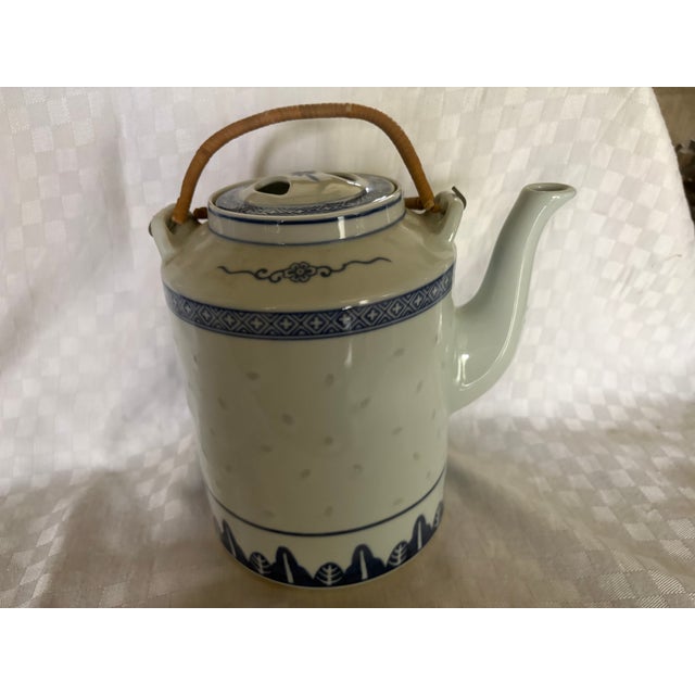This Chinese porcelain teapot is large enough for 8 cups of tea.. It is white porcelain with rice grain embossing and blue...