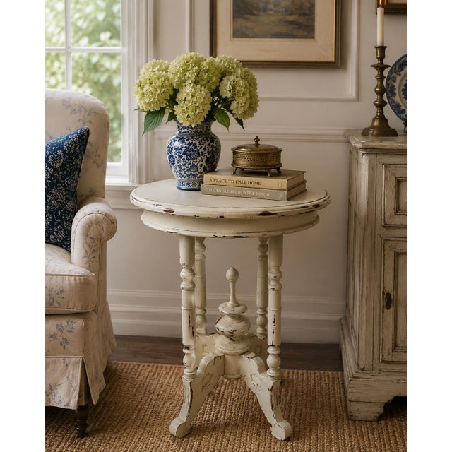 A beautiful Victorian style side table crafted in carved walnut and painted in an aged cream color. The elegant turned...
