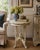 A beautiful Victorian style side table crafted in carved walnut and painted in an aged cream color. The elegant turned...