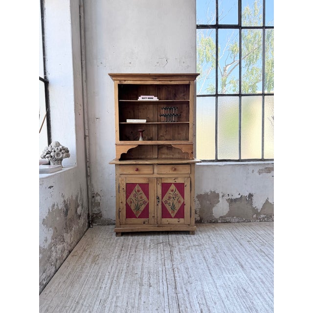 Antique pine grocery cabinet in the savoyard style, featuring polychrome paintwork and motifs, dating from the 1940s. Its...