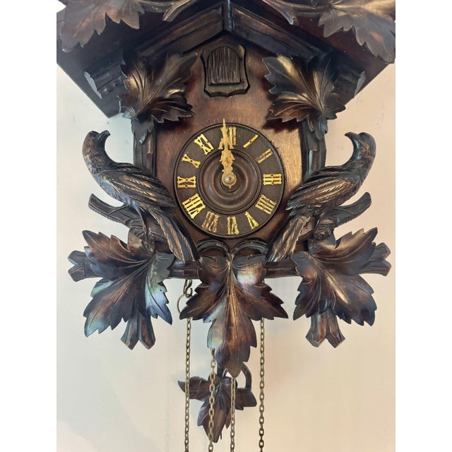 Fine quality antique 19th century Black Forest cuckoo clock having a quality carved case with carved leaves and two carved...