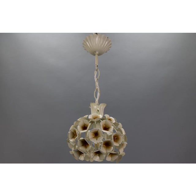 French Hollywood Regency style white flower pendant light, France, circa the 1960s. This adorable and compact-sized white...