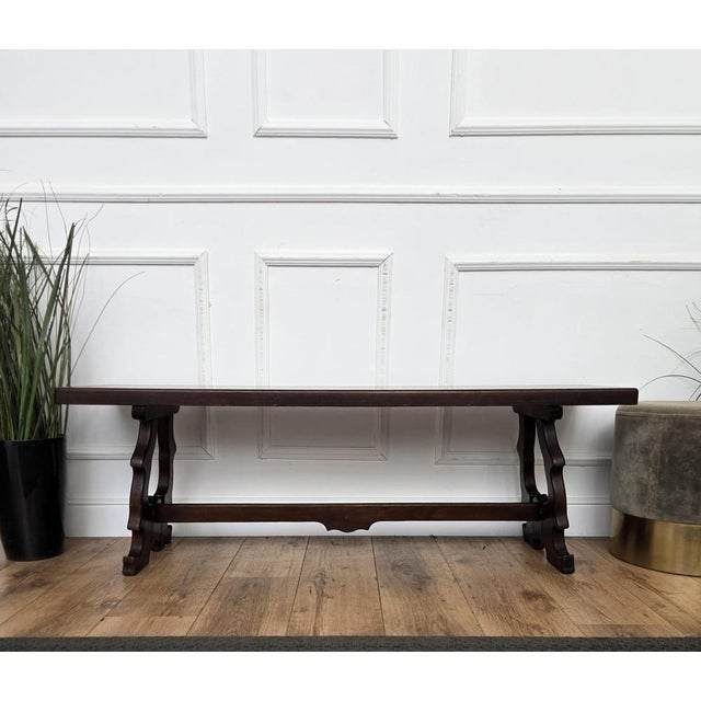 Beautiful Italian wooden bench, with trestle lyre shaped legs in dark brown wood color giving the rich and beautiful...
