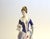 This refined Hollohaza porcelain figurine beautifully captures the grace and elegance of 18th‑century European fashion....