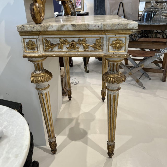 Imbue your home with a sense of historical grandeur with this 19th Century Italian Giltwood Console with Marble Top. Its...