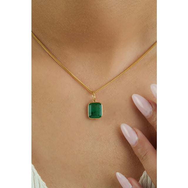 This solitaire pendant showcases a 3.66 carat of natural octagon emerald, set in 14K Yellow Gold. The emerald measuring...