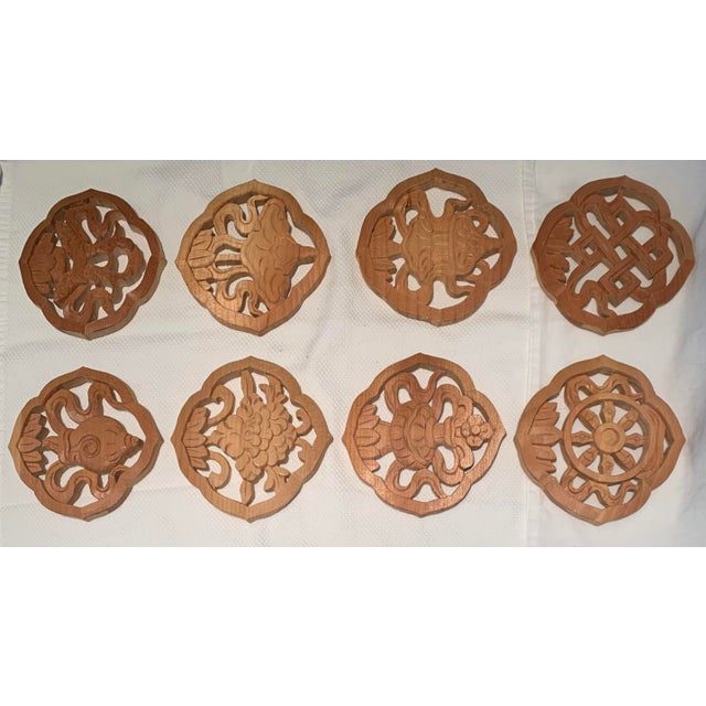 Hand carved vintage wood trivets. Each one different. Set of 8