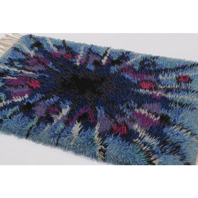 Hand-knotted in lush, high-pile wool in Sweden circa 1960-1970, this 4x6 vintage Swedish Rya rug is a bold new addition to...