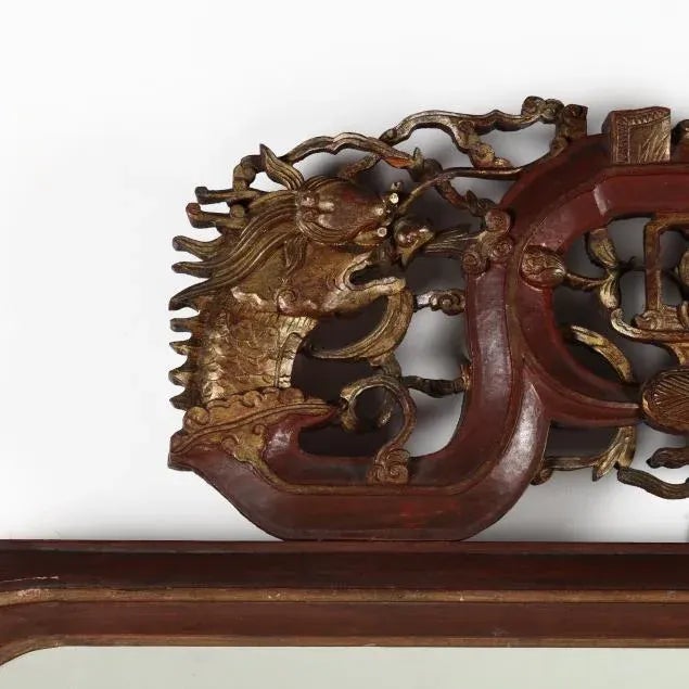 Early 20th Century, beveled mirror with rounded corners, carved wood frame with red lacquer and gilt highlight featuring a...