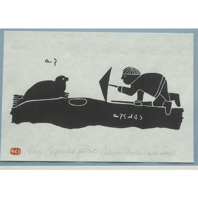 “Eskimo Hunter and Seal" by Henry Napartuk. Signed and titled in pencil. Framed size approx 14" x 11", print size 9.5" x...
