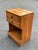 Bring classic mid-century craftsmanship and warmth to your bedroom with this vintage nightstand produced by the L.A....