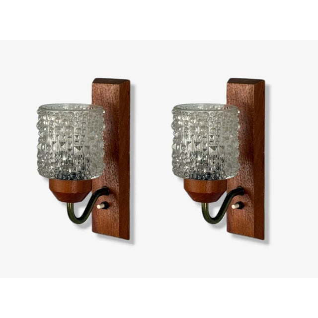 Danish Mid-Century Modern, Teak, Brass, Glass, Wall Lights or Sconces, Denmark, 1960s A pair of brass, teak, and sculpted...