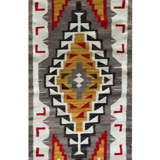An early 20th century Navajo rug with a wonderful geometric pattern including a large central diamond medallion floating...