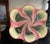 French majolica platter with a pink swirl pattern over a black and tan background, made around the 1920's