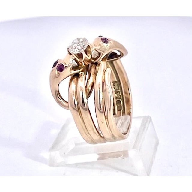 This snake ring is a lovers knot as it depicts 2 snakes wrapped together. The center holds a Diamond and the snakes have 4...