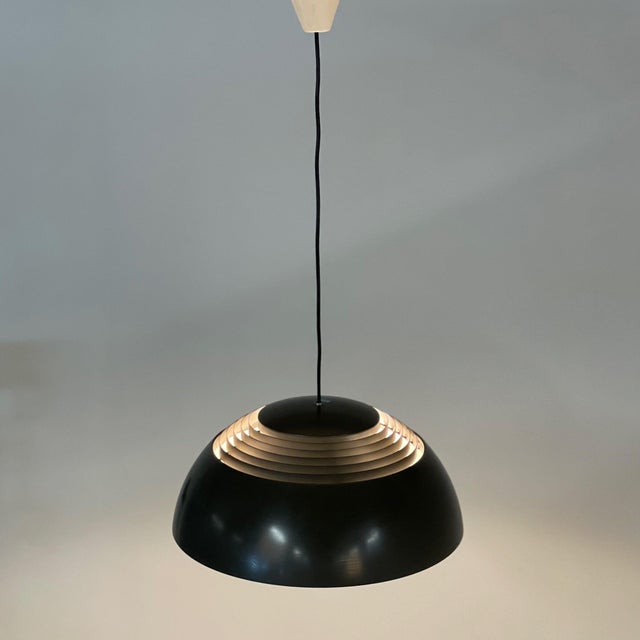 Brown aj pendant designed in 1957 by arne jacobsen for the sas royal hotel in copenhagen and manufactured in the 1970s by...