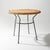 A round rattan and metal side table from the 1950s, a design that brings together the visual lightness of its structure...