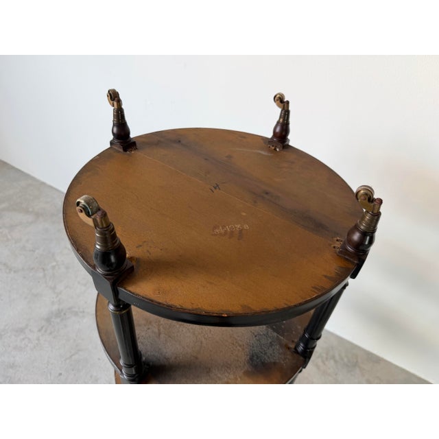 1960s Hollywood Regency Black Ebonized Three-Tier Side Table on Brass Casters For Sale - Image 11 of 12