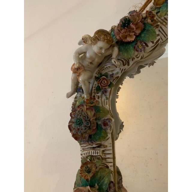 Beautiful German porcelain mirror with candlesticks Decorated with raised flowers and putti The base is decorated with...