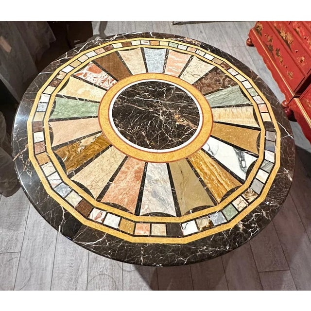Regency-style carved gilt marble specimen table top round center table. An exquisite Regency-style center table with a...