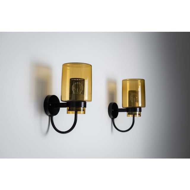 This elegant vintage pair of wall lamps showcases a timeless combination of materials and design. Each lamp features a...