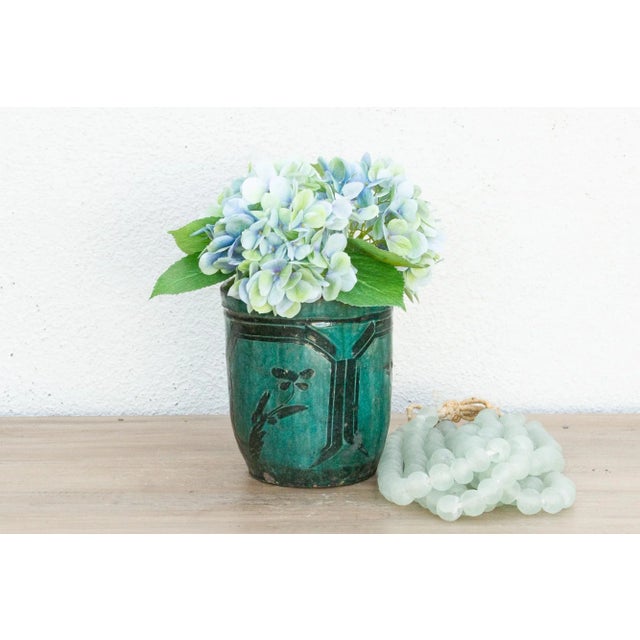 A vintage beautifully glazed porcelain vase with a flowers and birds design. This vintage Asian pottery piece has a...