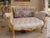 This elegant late 20th-century French Louis XVI–style settee combines refined neoclassical form with romantic textile...