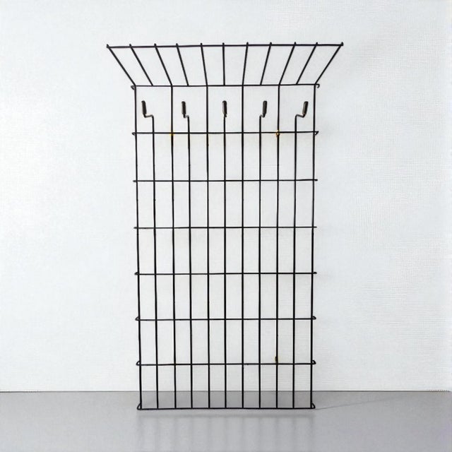 This simple and stylish vintage coat rack made of black metal was manufactured in Germany in the 1950s and 1960s by...
