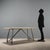 1970s table with a distinctive design combining a chrome-plated aluminum tubular base with a marble top. The aluminum...