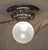 Art Nouveau ceiling lamp, circa 1915. Gometrically embossed brass. Original glass shade with a delicate blue tint. The...