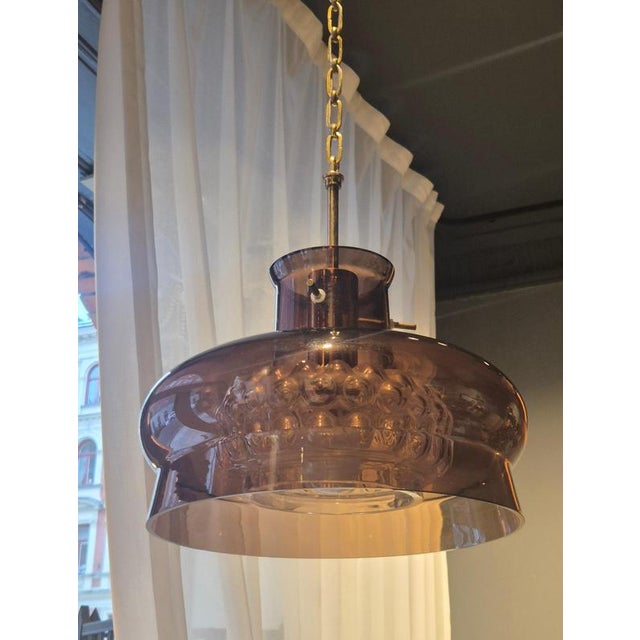 A Scandinavian Modern Classic, Glass pendant model 2190/117 by Carl Fagerlund for Orrefors, 1970s One glass shade with...