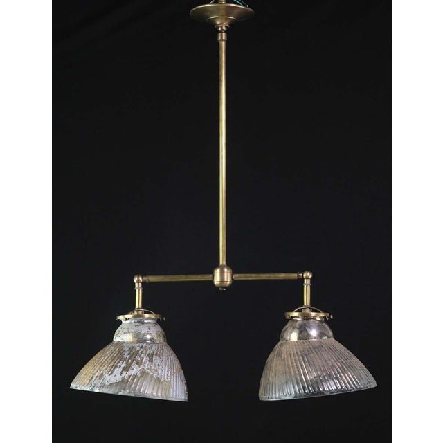 Antique mercury glass X-Ray shades mounted on a newly made brass double light fixture with articulating arms. The paint on...
