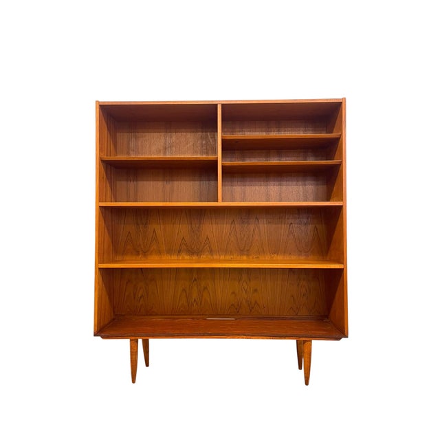 Vintage Danish modern open bookcase featuring a clean, minimalist silhouette and warm wood grain throughout. The case is...