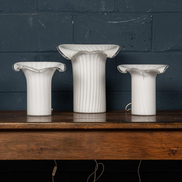 An elegant set of three Murano glass table lamps made in Venice, Italy in the 1980s. Known as the “calla“ (or lily) model,...
