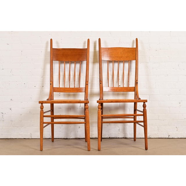 A gorgeous pair of antique Arts & Crafts or Early American side chairs or dining chairs In the manner of Charles P....