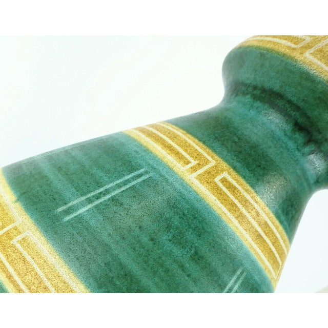 This piece is a floor vase from the 1960s by Bay-Keramik, West-Germany. Model no. 680-40 in various shades of green and...