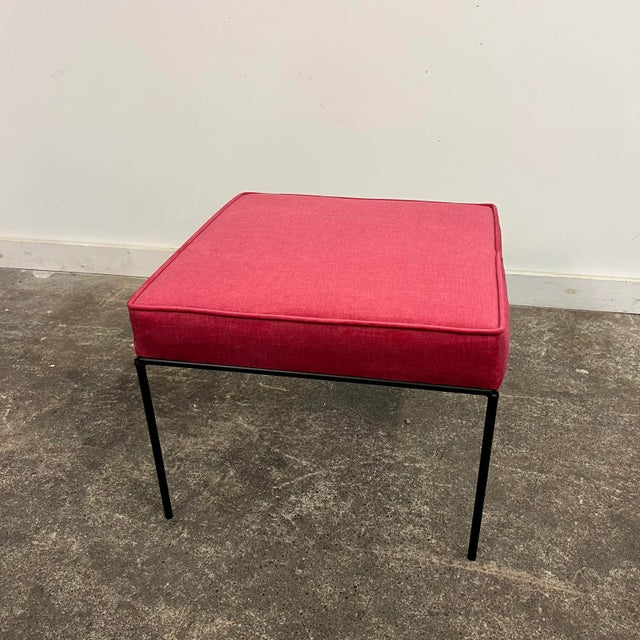 Ottoman/stool based off a design by Paul McCobb. This piece has an iron base and was covered in a dark pink velvet fabric.