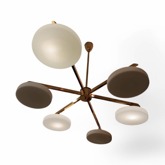 Ceiling lamp by the distinguished Italian designer Angelo Lelli from the 20th century. It has a central golden brass...