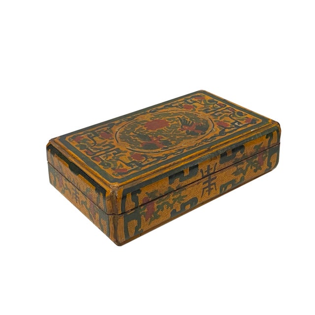 This is a handmade Chinese accent decorative box made of wood and finished with a distressed yellow base color. The...