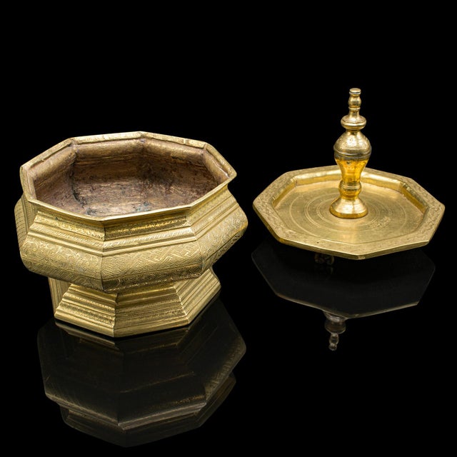 This is an antique temple betel nut dish. An Indonesian, engraved brass sireh stand, dating to the early Victorian period,...