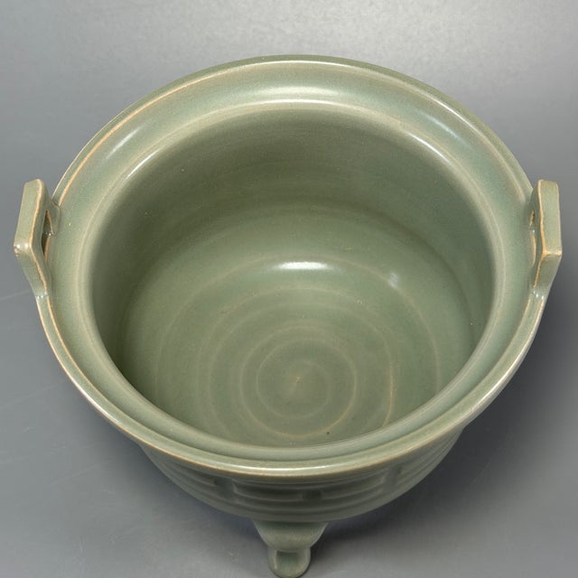 This elegant tripod censer is crafted in classic Chinese Longquan celadon style. Designed with two upright rectangular...