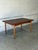 This elegant rectangular dining table expands effortlessly to accommodate extra guests. Slender tapered legs provide a...