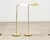 A refined matching pair of patinated mid-century modern brass pharmacy floor lamps made in the style of similar lamps by...