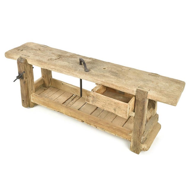This antique wooden workshop workbench embodies the robustness and craftsmanship of early 20th-century workshops. Carved...