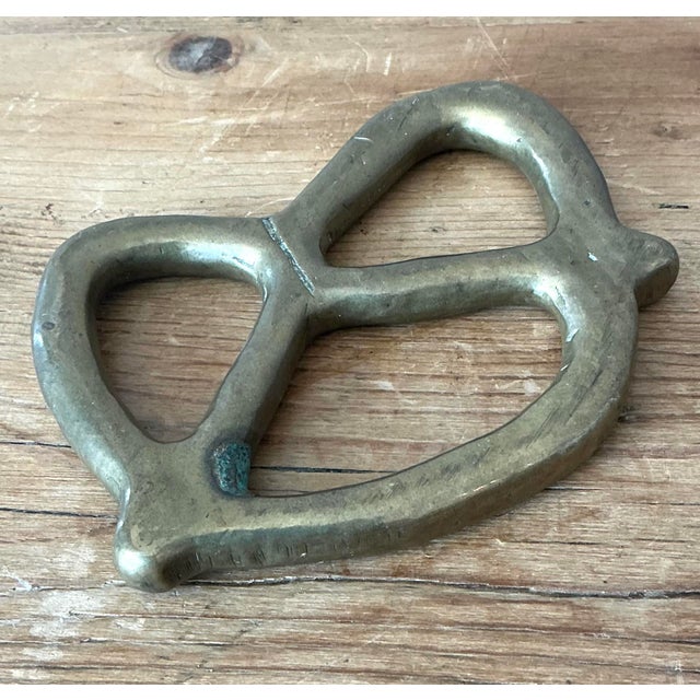 Add a touch of whimsical sophistication to your workspace or living area with this charming vintage solid brass pretzel...