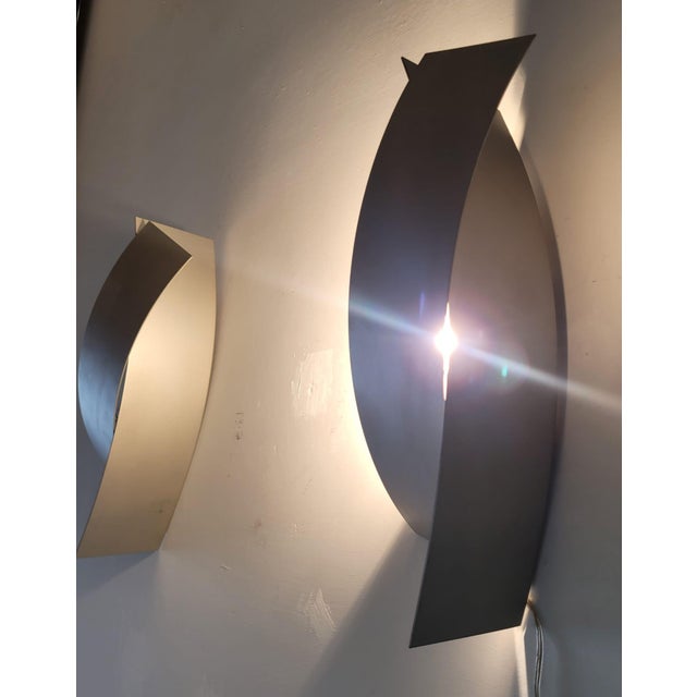 An elegant pair of Kiasma wall lamps, designed by renowned architect Steven Holl for FontanaArte – Candle line, produced...